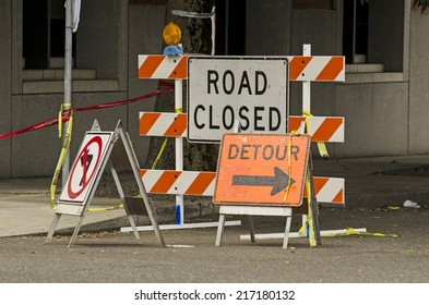 Road Closed And Detour Signs At A Downtown Urban Construction Site