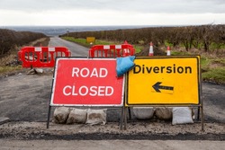 Road Closed And Diversion Signs With Red Barriers And Traffic Cones On A Rural Road In The Yorkshire Wolds, East Yorkshire, Winter 2024.   Horizontal.  Space For Copy.