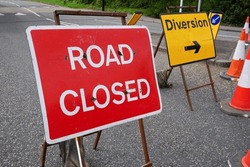 Road Closed And Diversion Signs At Road Works Site. Traffic Bollards At Road Blockade In The UK 
