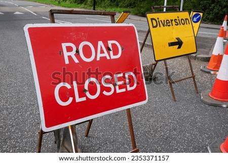 Road Closed and Diversion signs at road works site. Traffic bollards at road blockade in the UK 