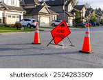 A Road Closed sign accompanied by traffic cones blocks a residential street in Mission, BC, Canada, highlighting urban development or maintenance.