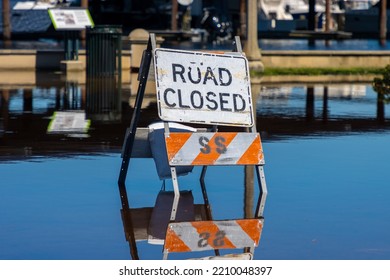 Road Closed Sign And Barrier On Flooded Street After Torrential Rain Storm