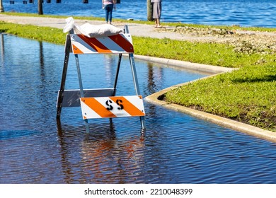 Road Closed Sign And Barrier On Flooded Street After Torrential Rain Storm