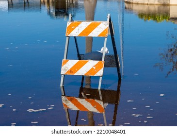 Road Closed Sign And Barrier On Flooded Street After Torrential Rain Storm