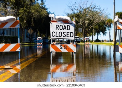 Road Closed Sign And Barrier On Flooded Street After Torrential Rain Storm