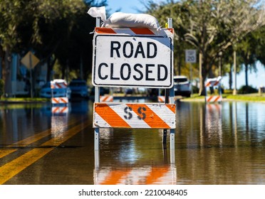 Road Closed Sign And Barrier On Flooded Street After Torrential Rain Storm