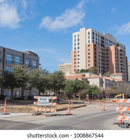 Road Closed Sign In Downtown Irving, Texas, USA Under Cloud Blue Sky. Barricade Closures, Cones With Construction Equipments And High-rise Building In Background.