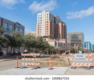 Road Closed Sign In Downtown Irving, Texas, USA Under Cloud Blue Sky. Barricade Closures, Cones With Construction Equipments And High-rise Building In Background.