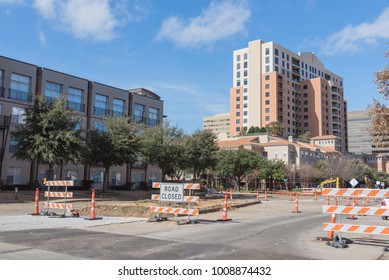 Road Closed Sign In Downtown Irving, Texas, USA Under Cloud Blue Sky. Barricade Closures, Cones With Construction Equipments And High-rise Building In Background.