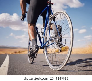 Road, closeup and man on a bike for cycling, race training or travel in the countryside. Health, exercise and legs of male cyclist or athlete with a bicycle for a workout, street cardio or triathlon - Powered by Shutterstock