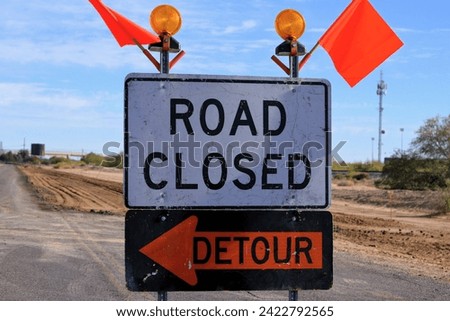 road closure detour signs and orange caution flags rural Arizona
