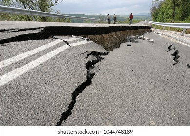 Road collapses with huge cracks. Flood damage highway. Asphalt road collapsed and fallen after heavy flood or earthquake