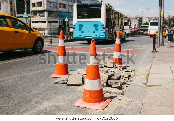 Road cone on the road. Road sign. Road\
works on the streets of Istanbul in Turkey.\
Sign.
