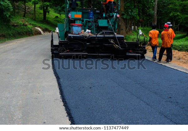 Road construction crew\
paves a new lane