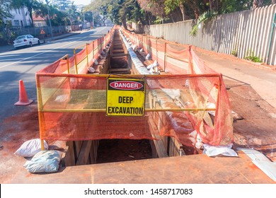 Road Construction Earthworks Deep Trench With Protection Safety Cloth Textile And Sandbags For New Electricity Power Cables Installation Infrastructure In Resident Areas.