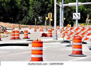 Road Construction Site With Orange Barrels New Traffic Signals Soon To Be Activated And Left Turn Arrows. 