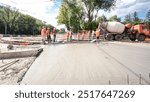 Road construction site with tram tracks repair and maintenance timelapse hyperlapse. Fresh concrete pouring on a metal grid. The middle part of intersection.