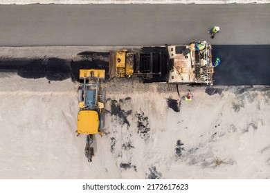 A Road Crew Paving A New Street