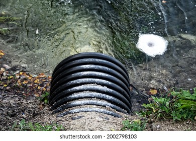 Road Culvert In The Winter. The Water Froze In The Ditch (side Drain)