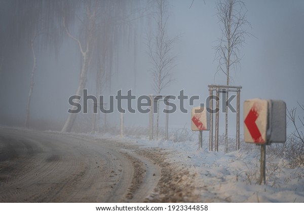 a  road curve in the fog while the world is sunk in
the snow