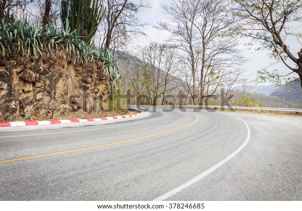 Road\
curve in the mountain, dangerous be ware to\
drive