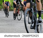 Road cycling race wheels on uphill paved road