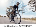 Road, cyclist or man in speed for training, competition and cycling race with endurance in Denmark. Outdoor, athlete and helmet for safety, fitness wellness and bike for sports adventure with energy