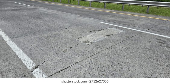 Road damage, rigid pavement, patching of cracked concrete.