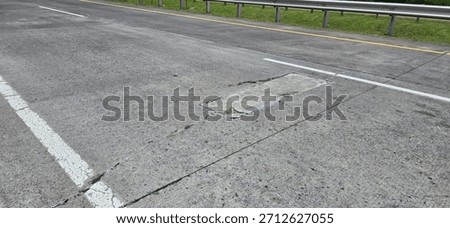 Road damage, rigid pavement, patching of cracked concrete.