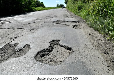 Road Destroyed After Winter. A Hole In The Road.