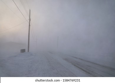 Road disappearing under blizzard conditions in Arviat, Nunavut Canada in winter conditions 