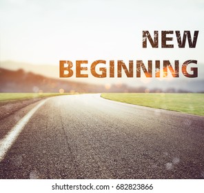 Road Disappears From The View At Sunset. Text New Beginning
