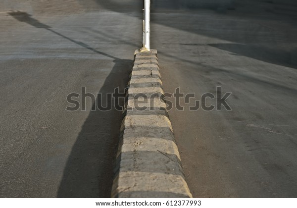 Road and a divider with an electric pole during\
early morning.