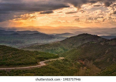 the road down from the mountains and the sunset