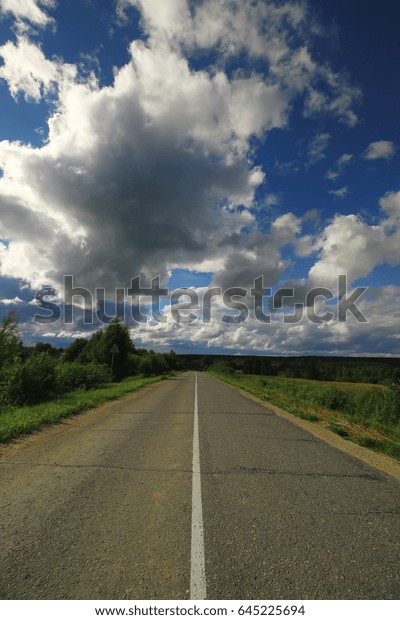 road in the field cloudy\
landscape
