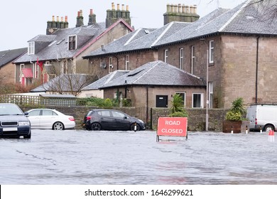 Road Flood Closed Sign Under Deep Water During Bad Extreme Heavy Rain Storm Weather In UK