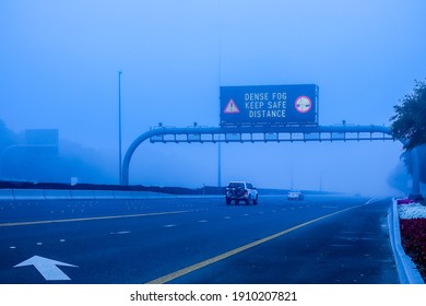 Road in the fog, sign mention keep distance for motorists at dubai road, foggy weather in UAE, Dense Fog keep Safe Distance banner in arabic and english - Shutterstock ID 1910207821