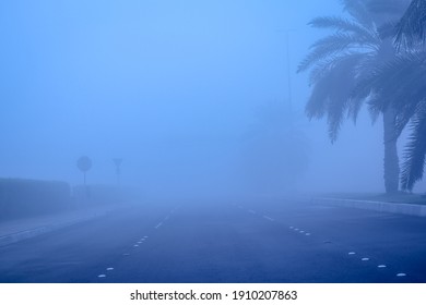 Road in the fog, sign mention keep distance for motorists at dubai road, foggy weather in UAE, Dense Fog keep Safe Distance banner in arabic and english - Powered by Shutterstock