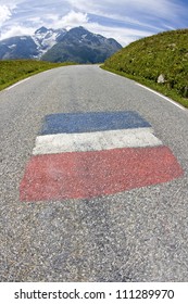 Road In French Alps, With Painted Flag. France.