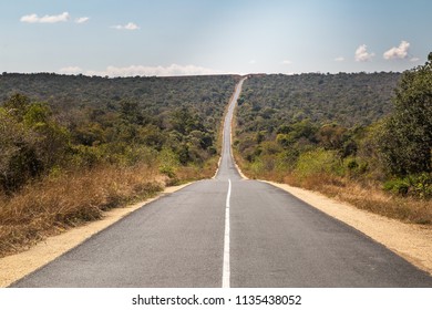 Road goes to horizon in the middle of nowhere, in the middle of grassland. Madagascar, August, Summer 2018