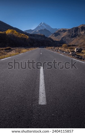 road going towards the mountains, Mount Kazbek in autumn