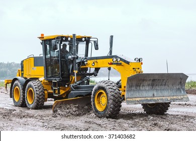 Road grader - heavy earth moving on dirty ground