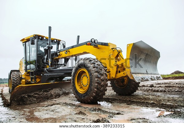 Road grader - heavy\
earth moving dirty 