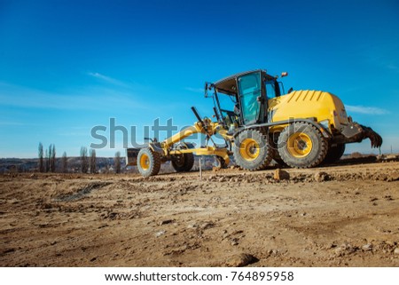 road grader on the sky background