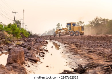 Road grader tractor working at road construction site, motor grader working on road construction