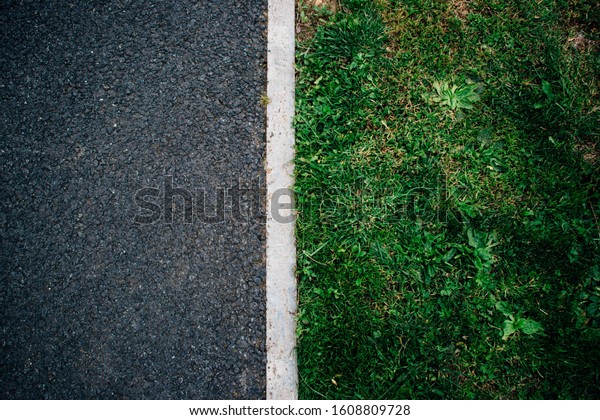 a road and grass\
divided by a white line