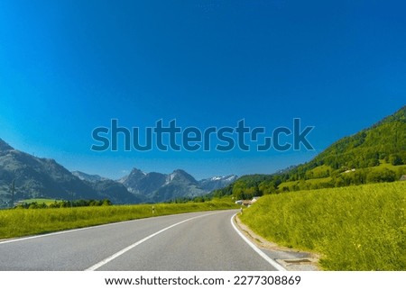 Road with green meadows and moutains near Haut-Intyamon, Gruyere, Fribourg Switzerland.