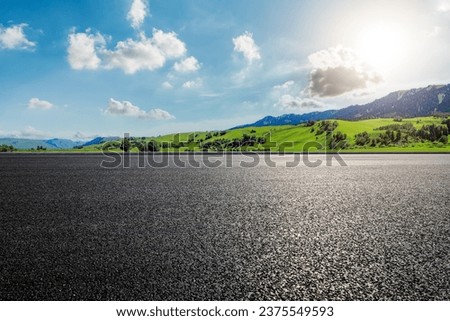 Road and green mountain landscape under blue sky