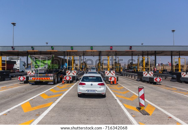 Road\
Highway Vehicles Toll  Gates\
Highway Tolls, South-Africa - Sept 15\
2017: Drivers View traveling road highway toll gate booths vehicle\
route  on N3 at  Mooi-River KZ-Natal\
South-Africa.