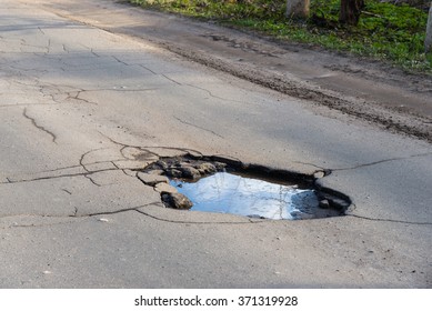 Road Hole. Repair Work, Grey Asphalt, Puddle